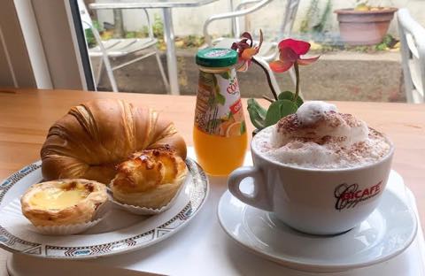 Coffee and pastries on a table outside