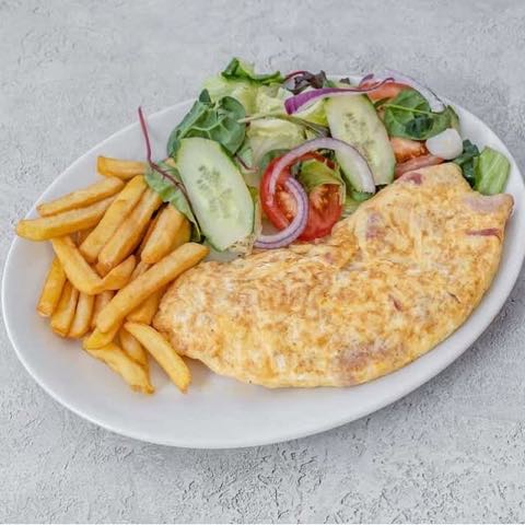 An omelette with chips and salad