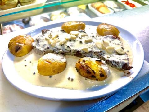 Grilled fish with potatoes in a cream and peppercorn sauce